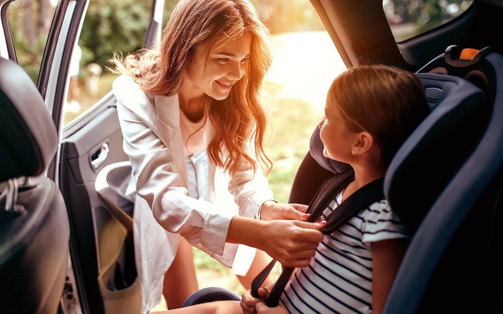 A,Cute,Woman,Mother,Put,Her,Daughter,In,A,Car Verkehrsunfall am Gehweg: Haftung im Fall des Türöffnens