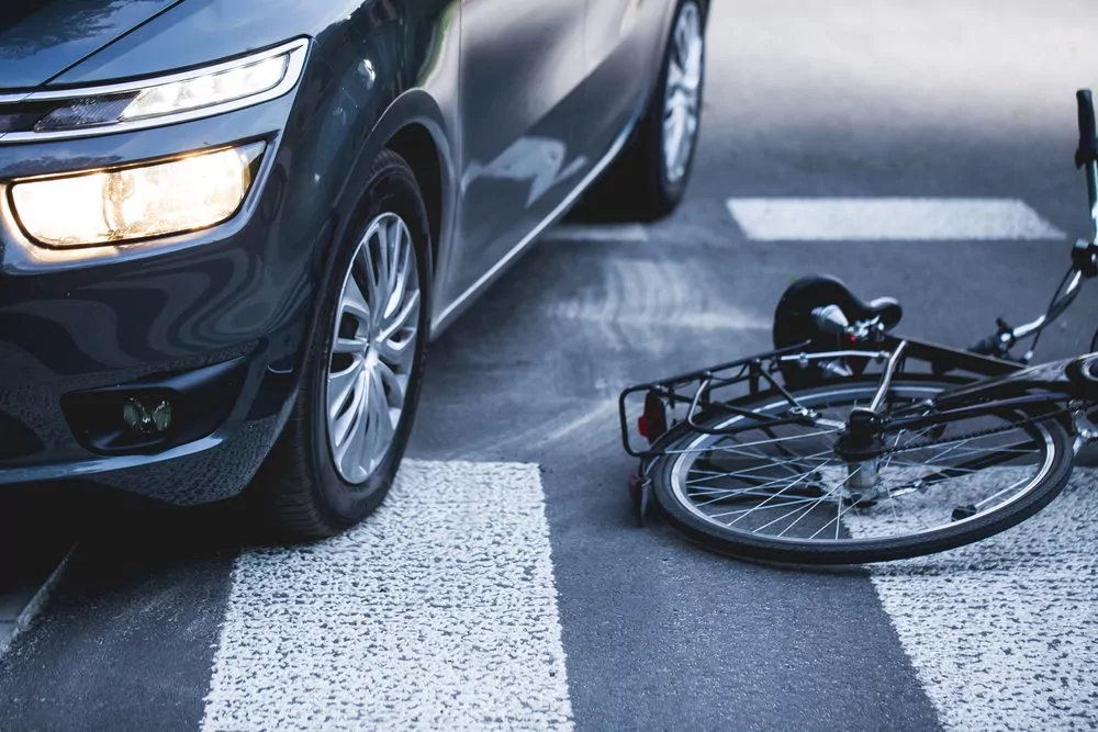 Car,Standing,On,The,Pedestrian,Path,With,The,Downed,Bicycle Haftungsfrage bei Kollision: Fahrrad trifft Auto am Zebrastreifen